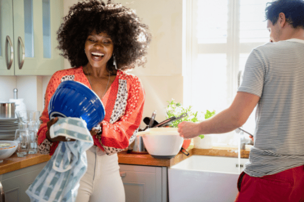 Couple doing dishes together, being thoughtful and timely with their actions and love